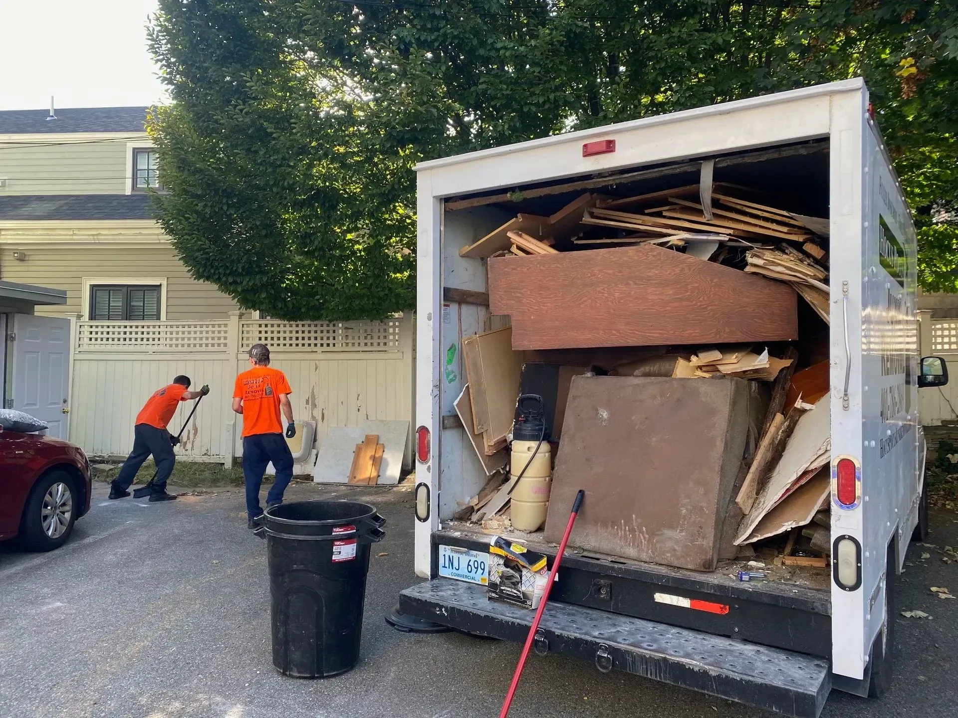 Hocus Pocus Junk Removal crew loading a truck with debris